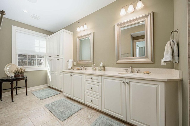 bathroom featuring tile patterned flooring and vanity