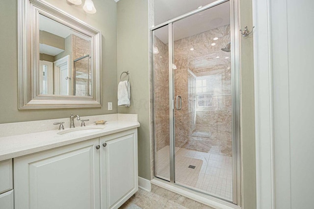 bathroom with tile patterned flooring, vanity, and a shower with door