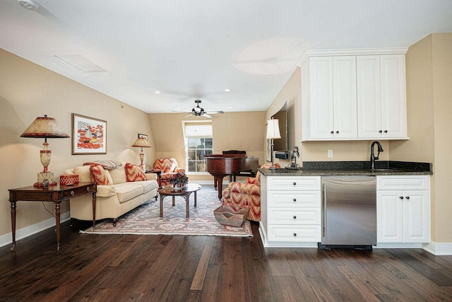 kitchen with stainless steel dishwasher, ceiling fan, sink, dark hardwood / wood-style floors, and white cabinetry