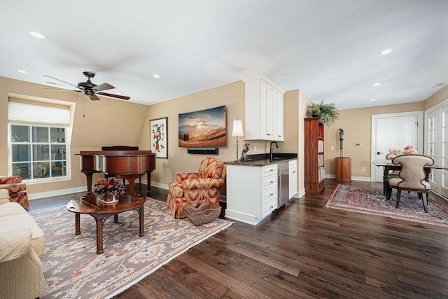 living room with ceiling fan, dark wood-type flooring, and sink