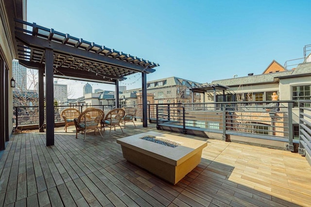 deck with a pergola and an outdoor fire pit