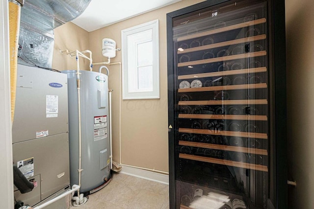 utility room featuring beverage cooler and water heater