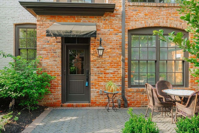 property entrance featuring a patio area