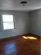 spare room featuring dark hardwood / wood-style floors