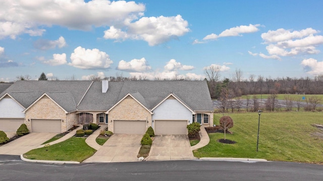 view of front of home featuring a front yard and a garage