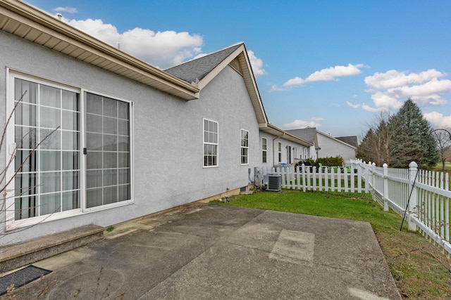 exterior space featuring a yard, a patio, and central AC unit