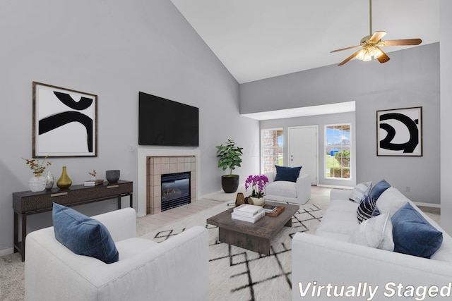 living room with a tile fireplace, high vaulted ceiling, and ceiling fan