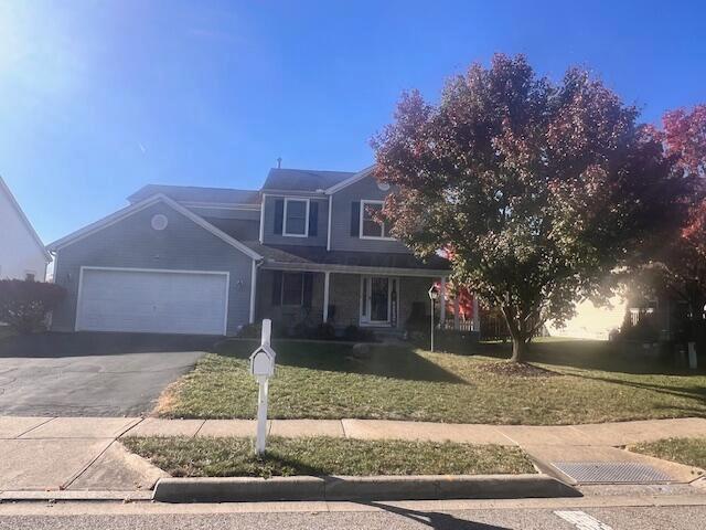 view of front property featuring a garage and a front yard