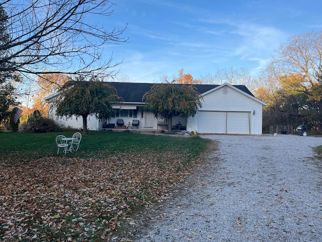 ranch-style home with a garage and a front lawn