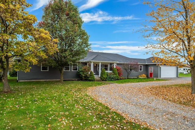 ranch-style house featuring a front yard and a garage