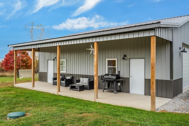 back of property with a lawn, a patio, and an outdoor hangout area