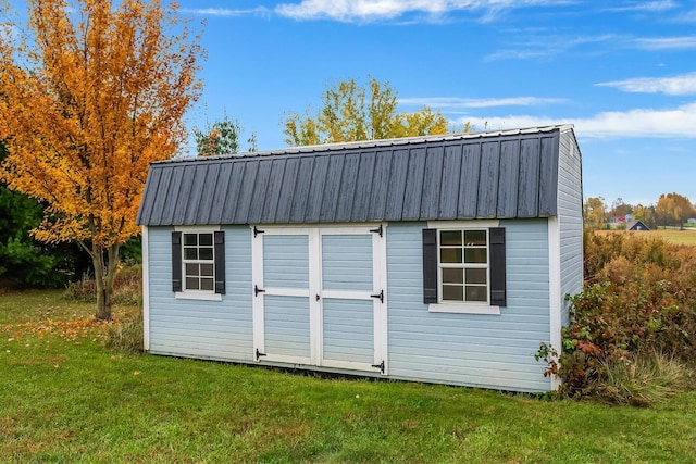 view of outbuilding featuring a yard