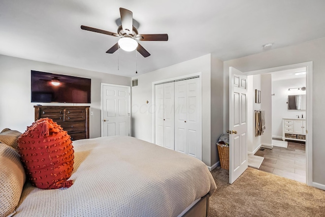 bedroom with carpet, a closet, ensuite bathroom, and ceiling fan