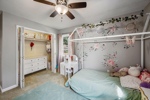 carpeted bedroom with a closet and ceiling fan