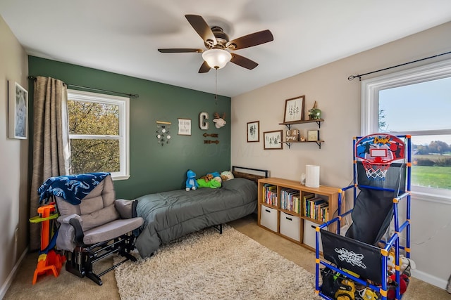 bedroom with ceiling fan and light colored carpet