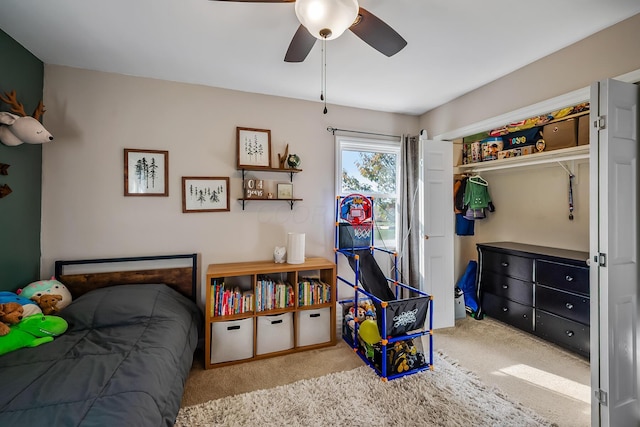 bedroom with a closet, light colored carpet, and ceiling fan