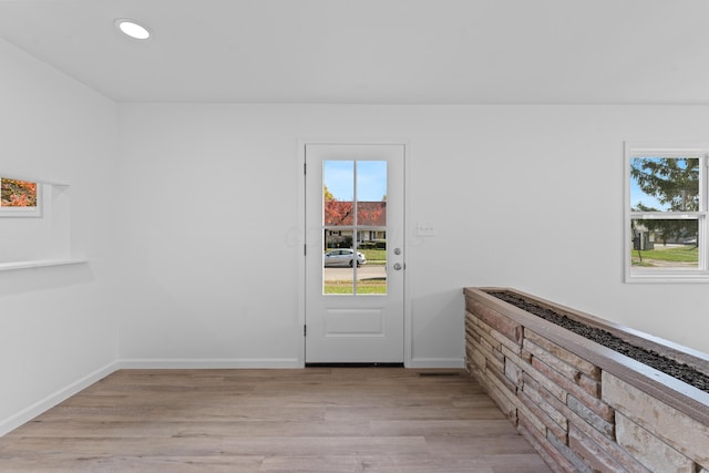 doorway to outside with light wood-type flooring