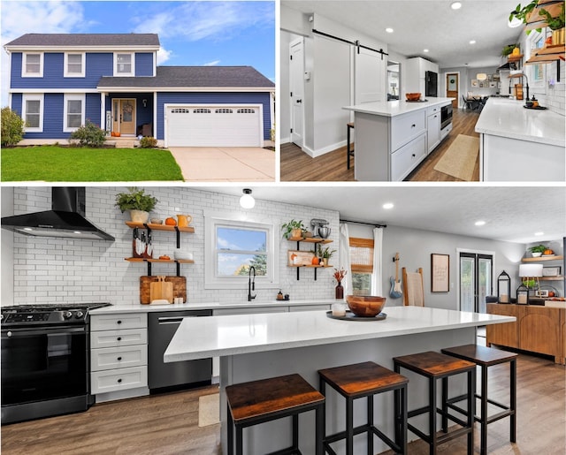 kitchen with stove, stainless steel dishwasher, wall chimney range hood, a barn door, and a kitchen island