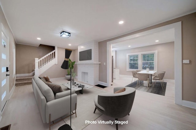 living room with a fireplace and light hardwood / wood-style floors