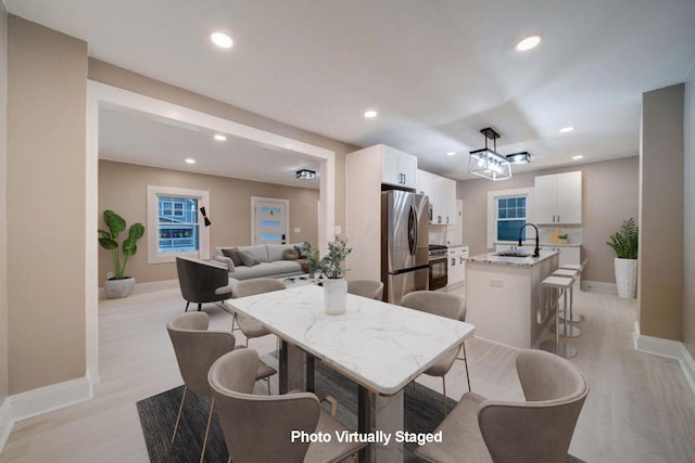 dining room featuring light hardwood / wood-style flooring and sink