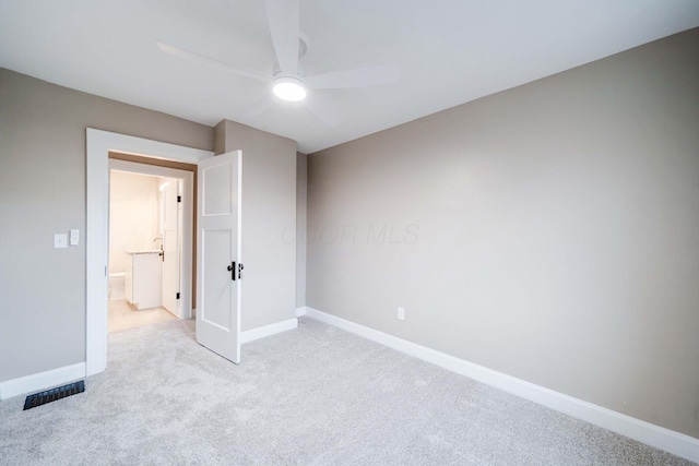 unfurnished room featuring light carpet and ceiling fan