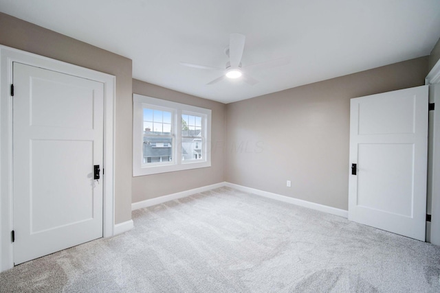 unfurnished bedroom featuring ceiling fan and light colored carpet