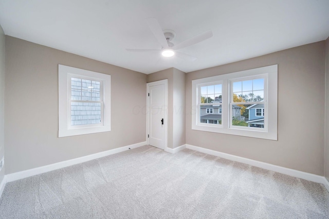 unfurnished bedroom with ceiling fan, light colored carpet, and multiple windows