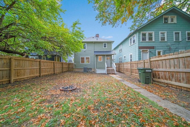 rear view of property featuring central AC unit