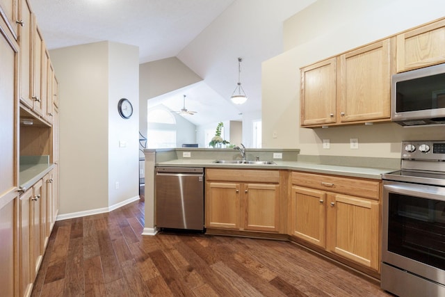 kitchen featuring lofted ceiling, decorative light fixtures, stainless steel appliances, sink, and ceiling fan