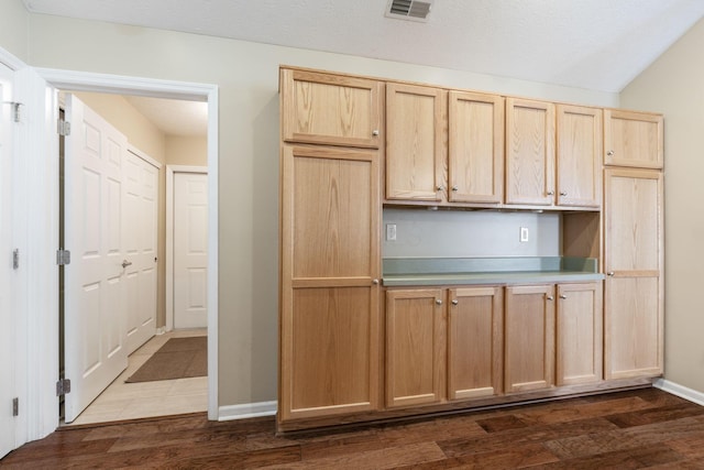 kitchen featuring light brown cabinets and dark hardwood / wood-style floors