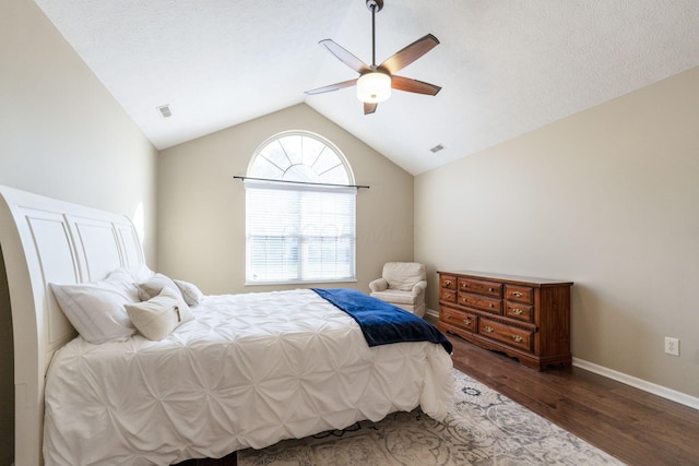 bedroom with ceiling fan, dark hardwood / wood-style flooring, and vaulted ceiling