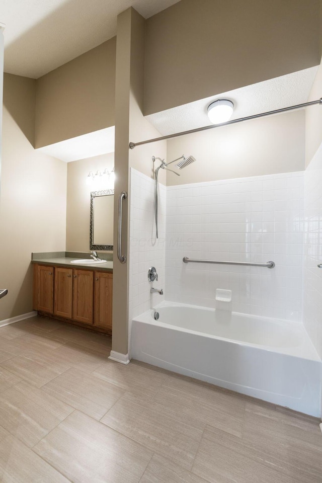 bathroom with vanity, tile patterned floors, and washtub / shower combination