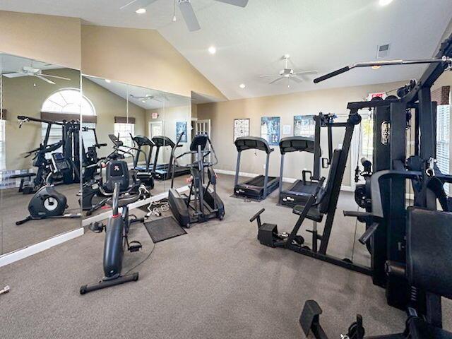 exercise room featuring ceiling fan and vaulted ceiling