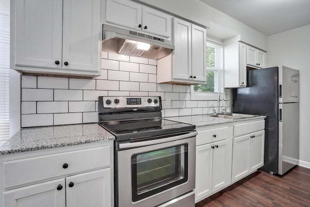 kitchen featuring backsplash, light stone counters, appliances with stainless steel finishes, dark hardwood / wood-style flooring, and white cabinetry