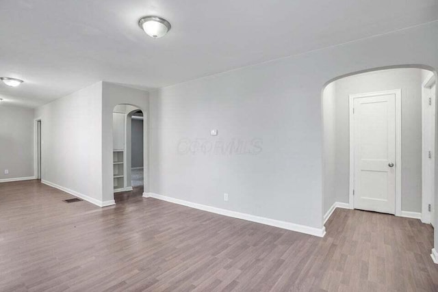 unfurnished room with hardwood / wood-style flooring