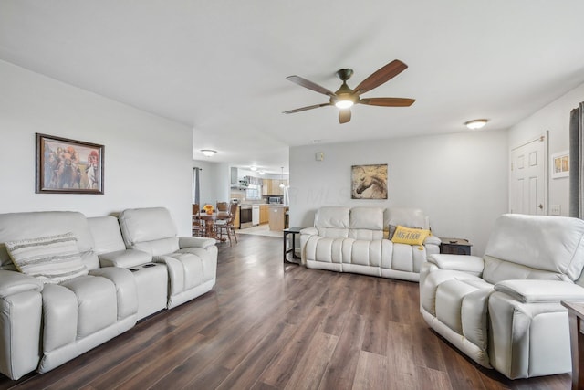 living room with ceiling fan and dark hardwood / wood-style floors