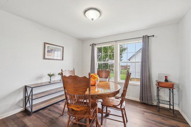 dining space with dark hardwood / wood-style floors