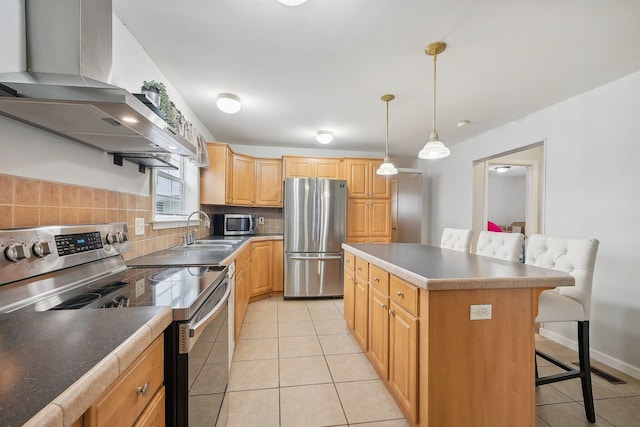 kitchen featuring a center island, a kitchen breakfast bar, decorative backsplash, range hood, and appliances with stainless steel finishes