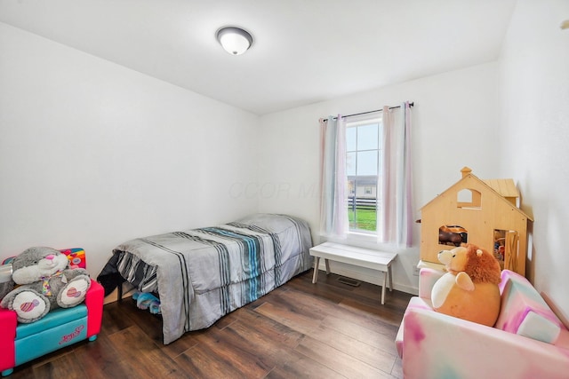 bedroom with dark wood-type flooring