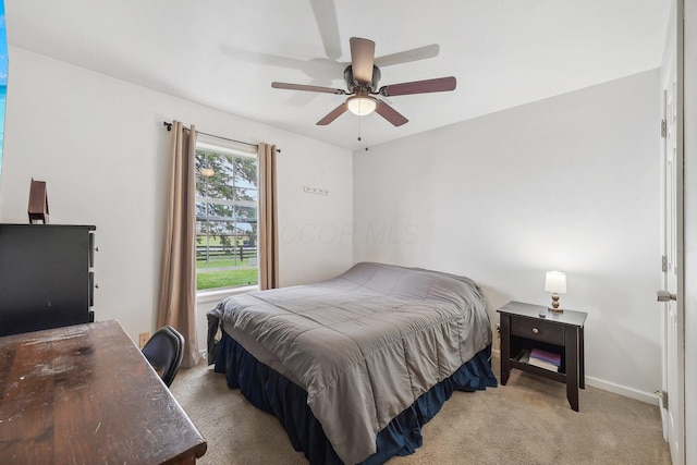 bedroom featuring light colored carpet and ceiling fan