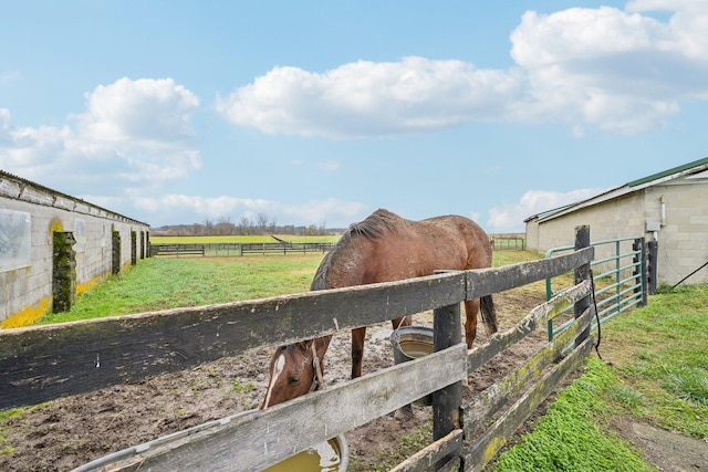 view of stable with a rural view