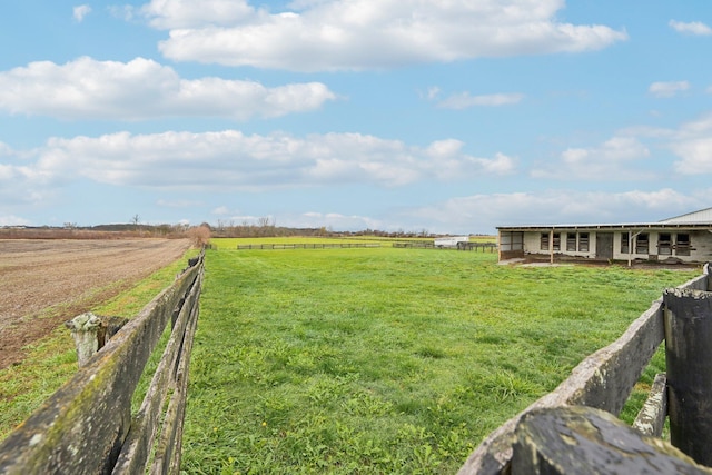 view of yard with an outbuilding and a rural view