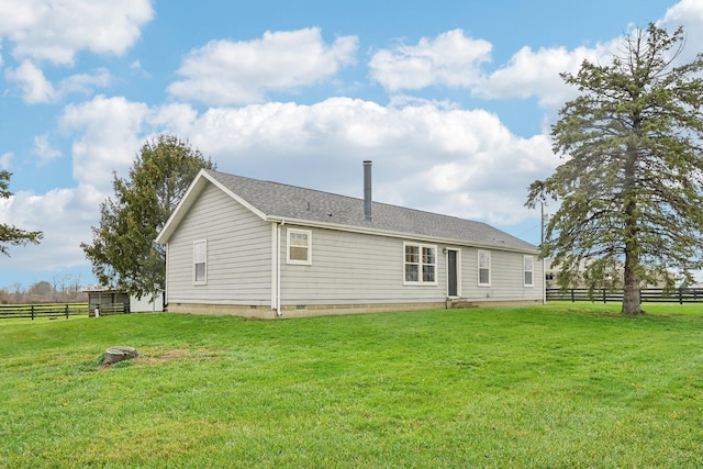 rear view of property with a lawn