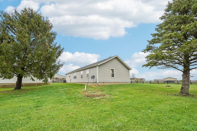 view of side of home featuring a yard