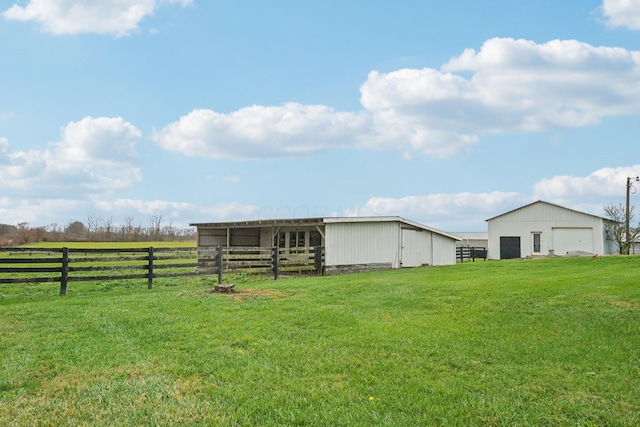 view of yard with a rural view and an outdoor structure