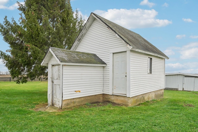 view of outbuilding with a yard