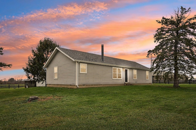 back house at dusk with a yard