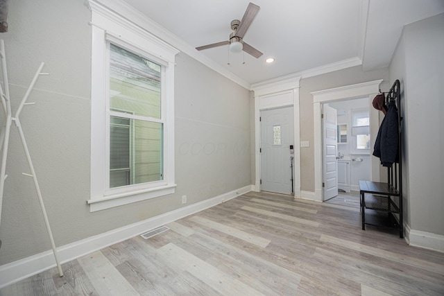 foyer featuring light hardwood / wood-style floors, ceiling fan, and ornamental molding