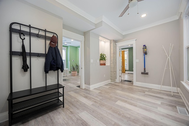 interior space featuring a healthy amount of sunlight, light wood-type flooring, and crown molding