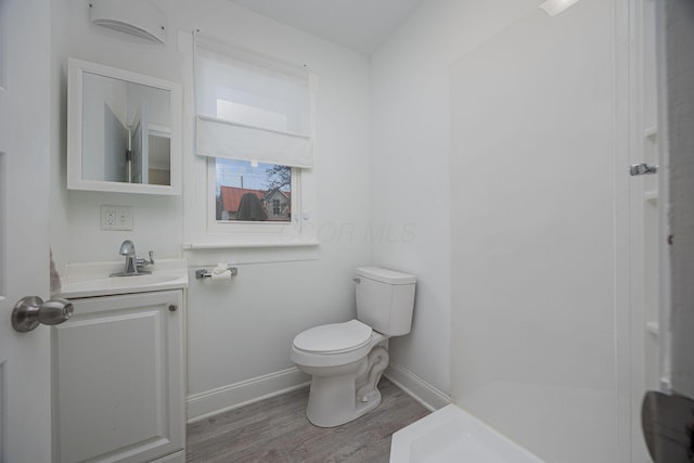 bathroom featuring vanity, wood-type flooring, and toilet